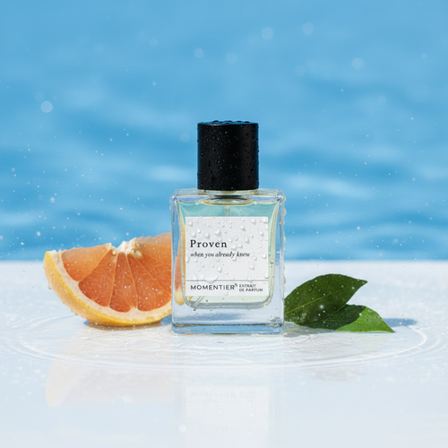 Proven perfume bottle in a white-tiled bathroom with a rolled towel and soap — Momentier fresh aquatic Extrait de Parfum