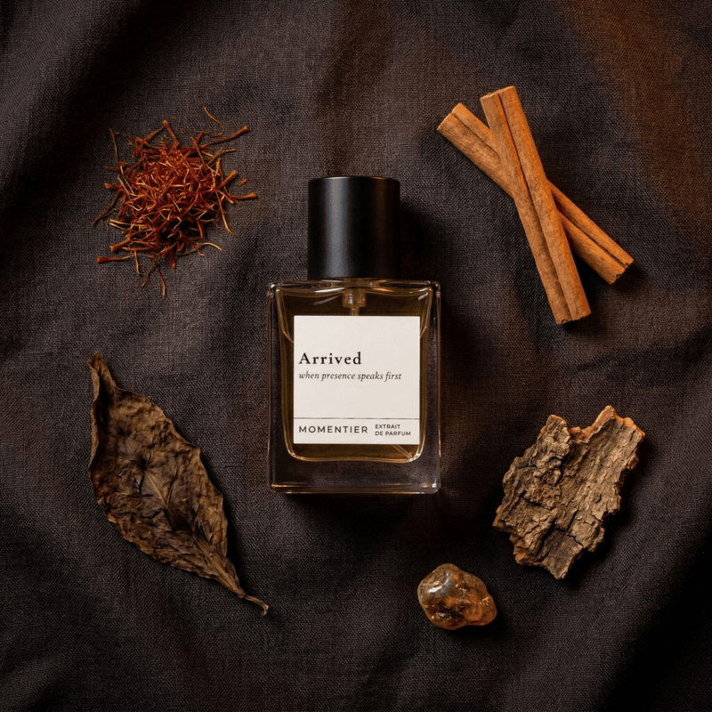 Arrived tobacco saffron perfume bottle surrounded by saffron, cinnamon, and natural elements on a dark background.