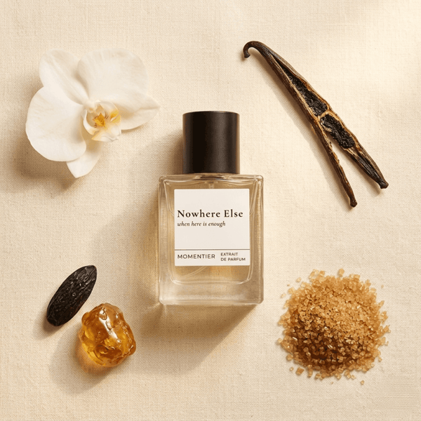 Nowhere Else vanilla-gourmand perfume bottle on cream with white orchid, vanilla pods, amber resin and brown sugar — Momentier Extrait de Parfum